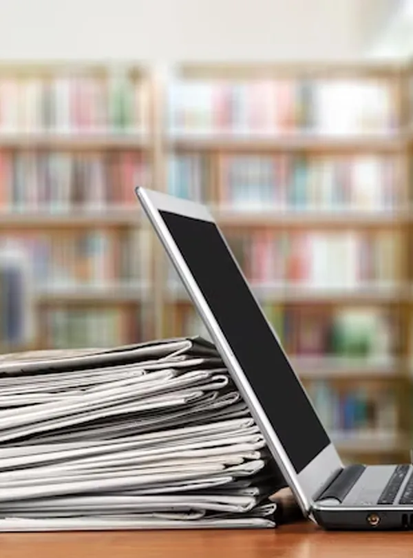 Laptop and newspaper