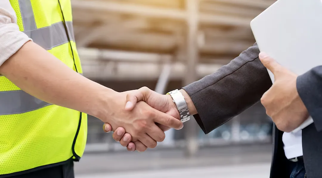 Drilling engineer and business professional shaking hands